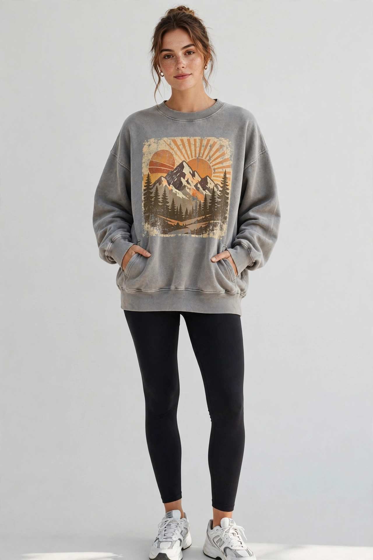 Woman wearing black leggings with an oversized graphic sweatshirt