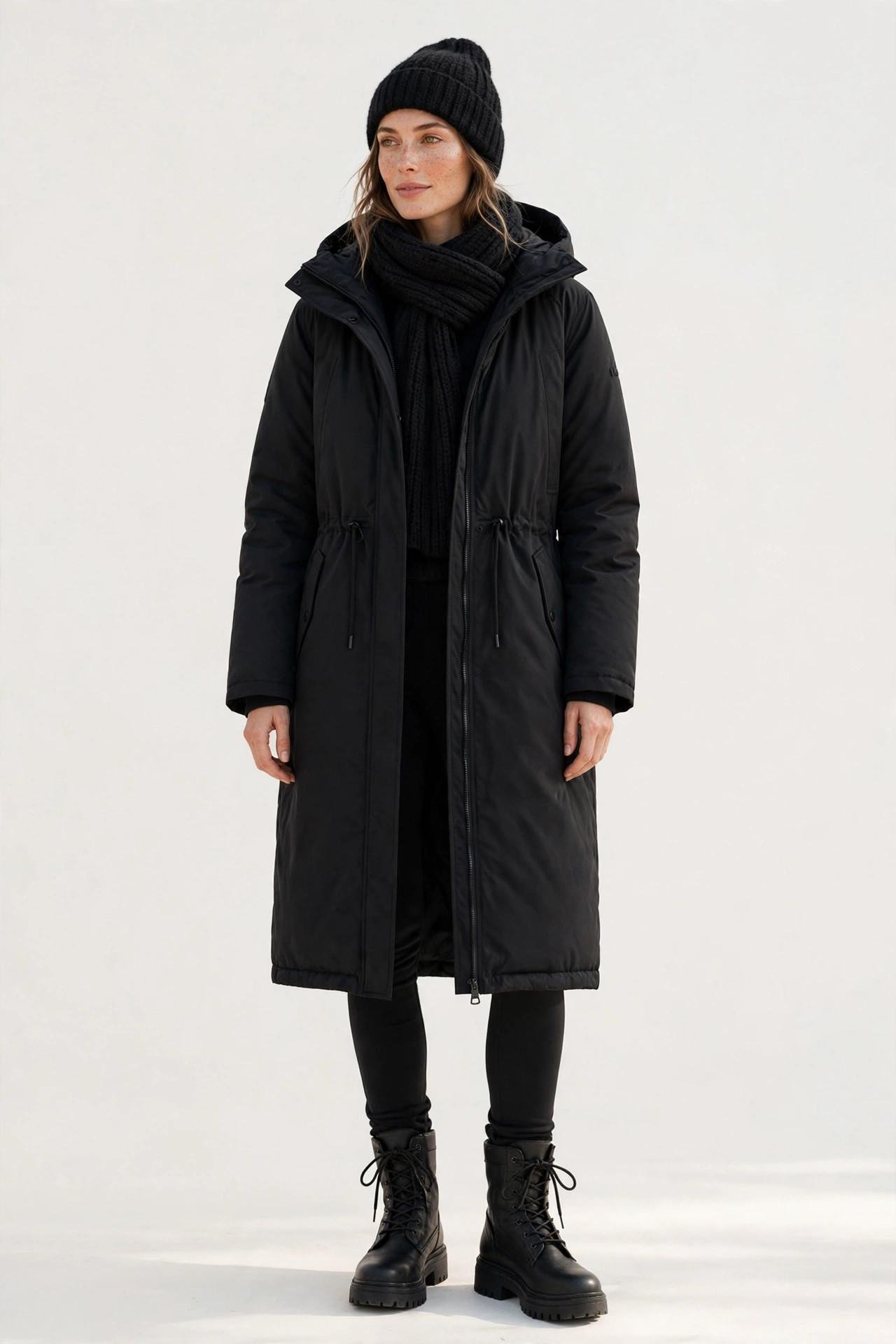Woman wearing a knit beanie and scarf set with a parka
