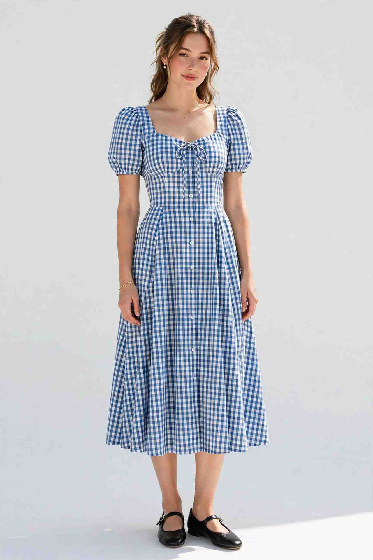 Woman wearing a gingham midi dress with Mary Jane flats