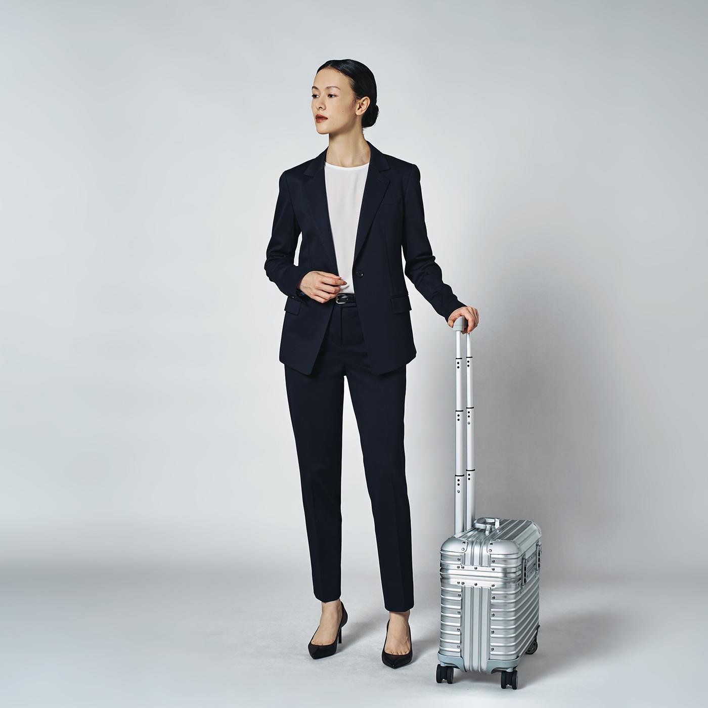Woman in tailored suit professional airport work outfit
