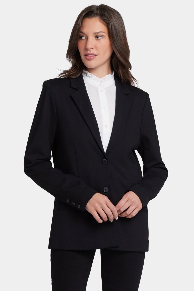 Woman in knit blazer comfortable professional travel outfit