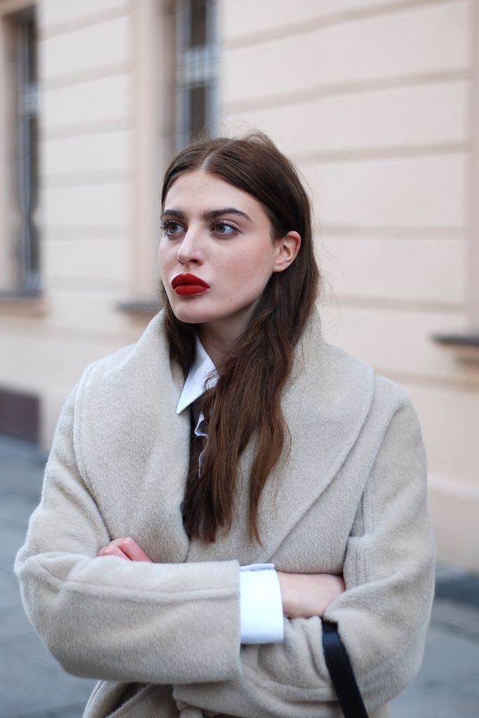 Woman in tailored wool coat polished business travel look