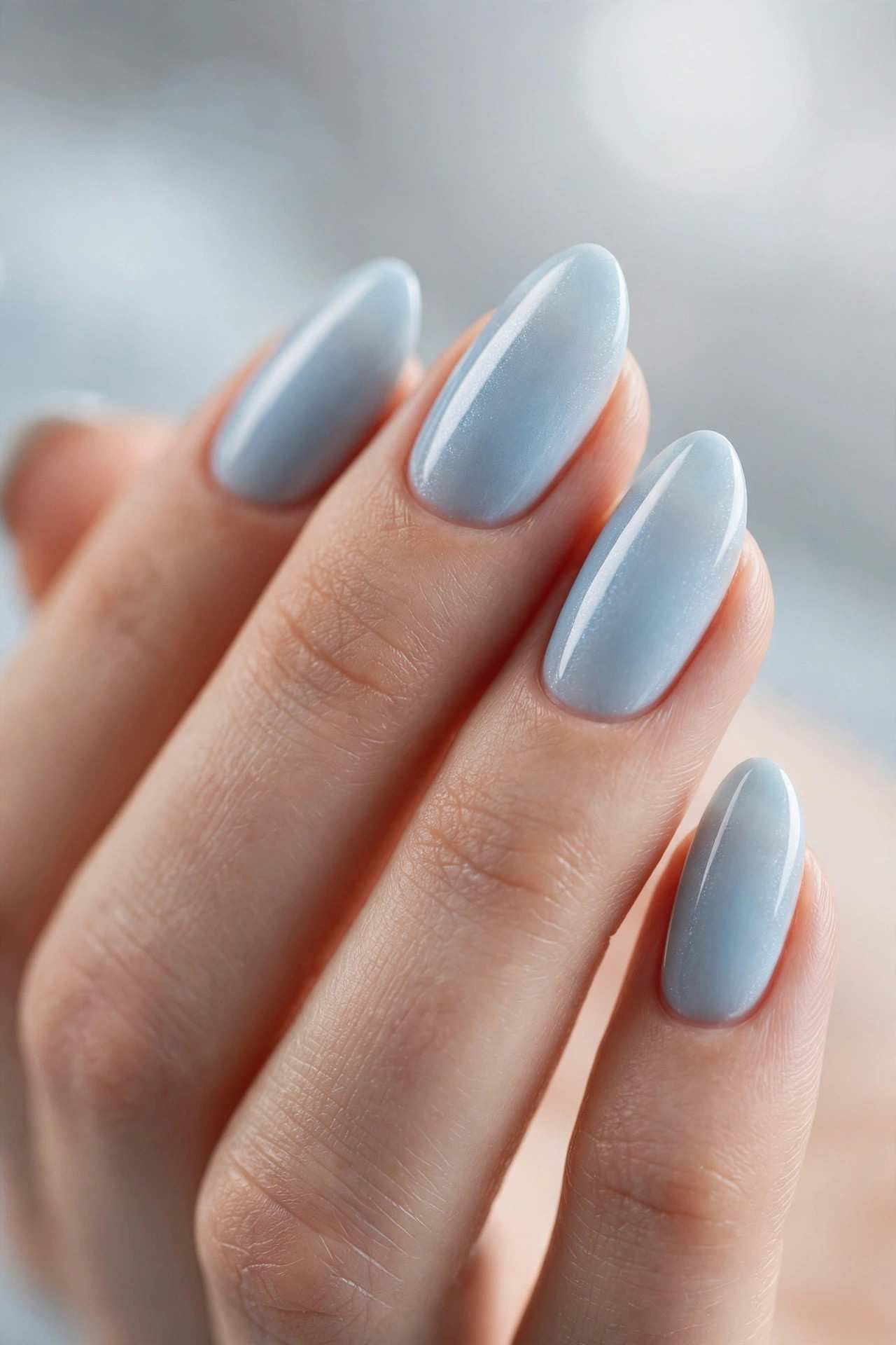 Short almond nails in icy blue winter polish