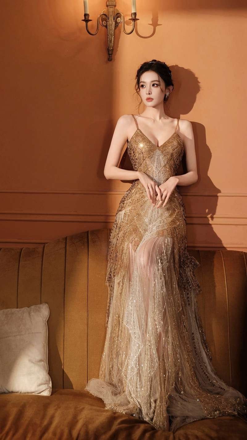 Woman in a gold floral maxi dress for evening