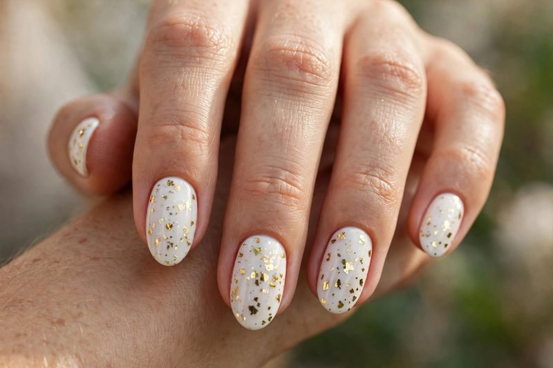 White and gold confetti almond nails for graduation
