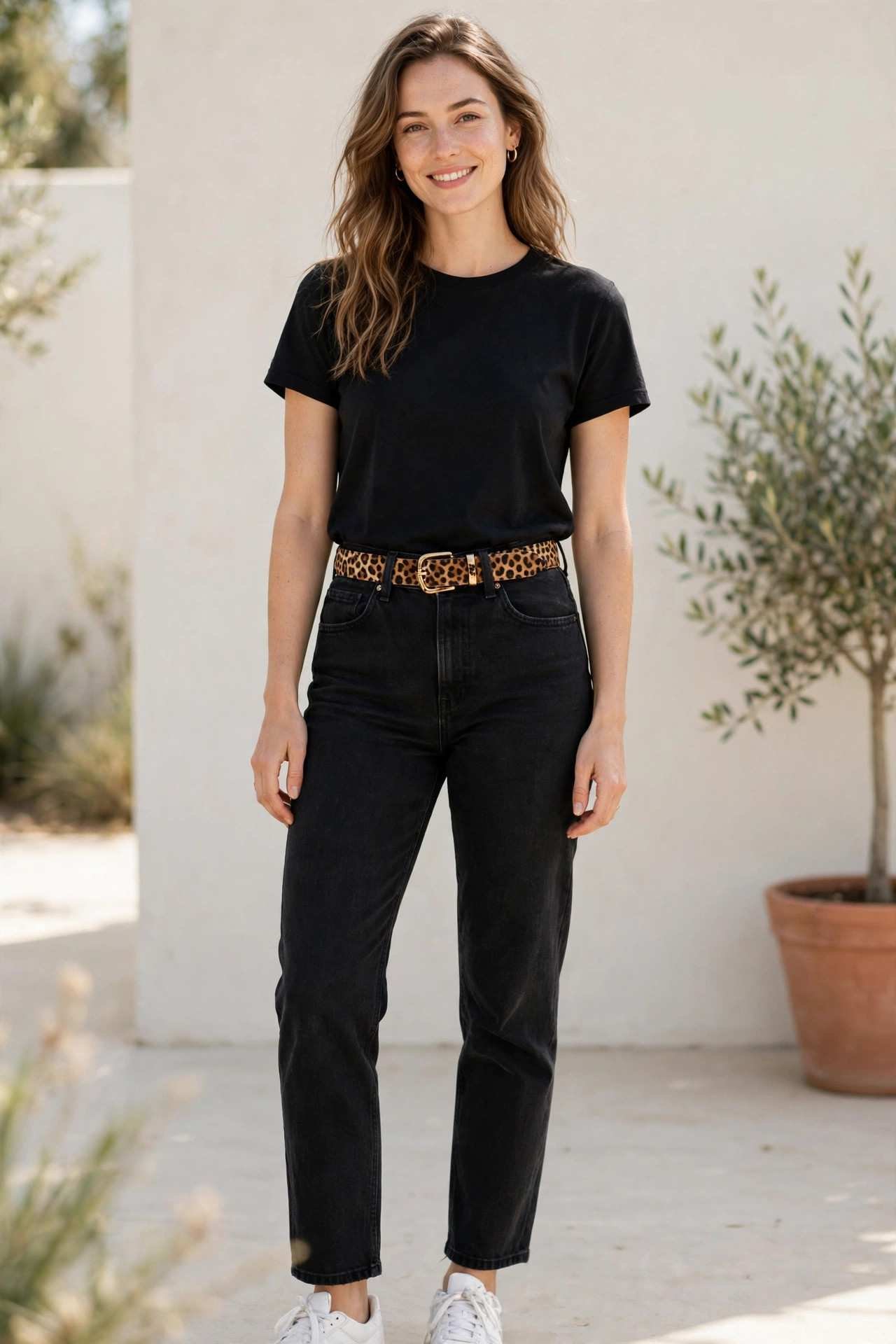 Woman in black jeans with a leopard belt
