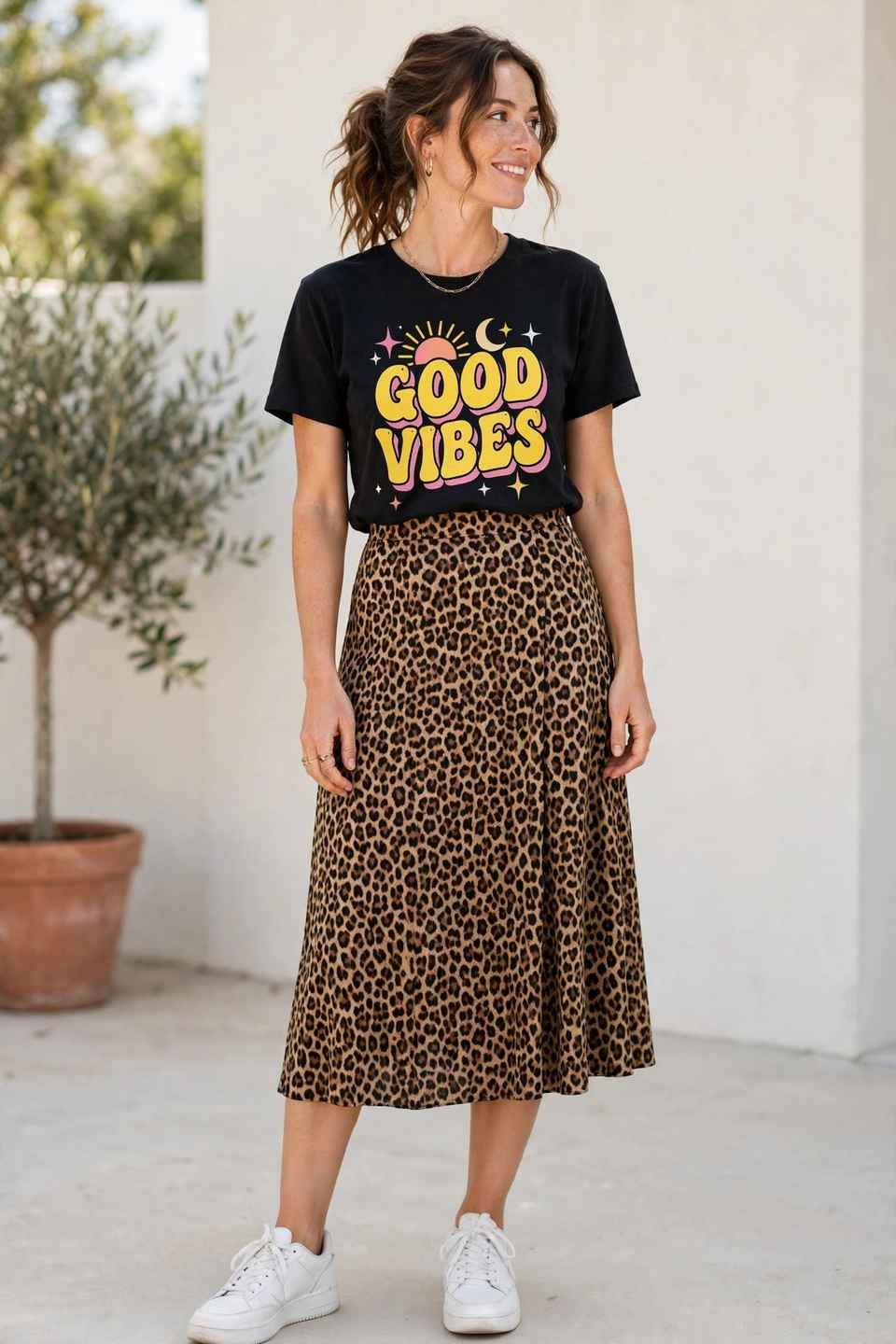Woman in a leopard skirt with a graphic tee