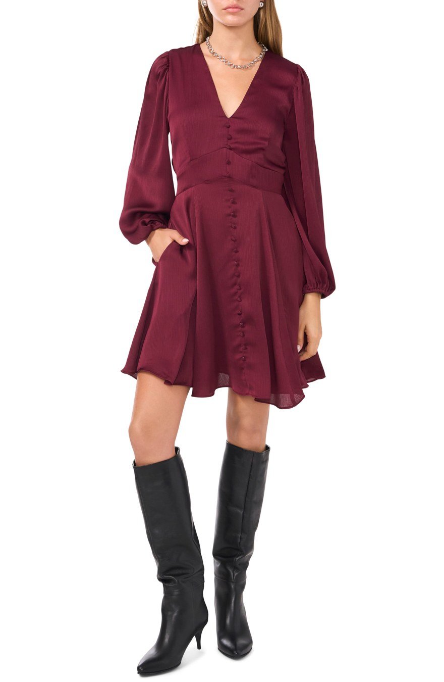 Woman in a wool coat and knee-high boots with a dress