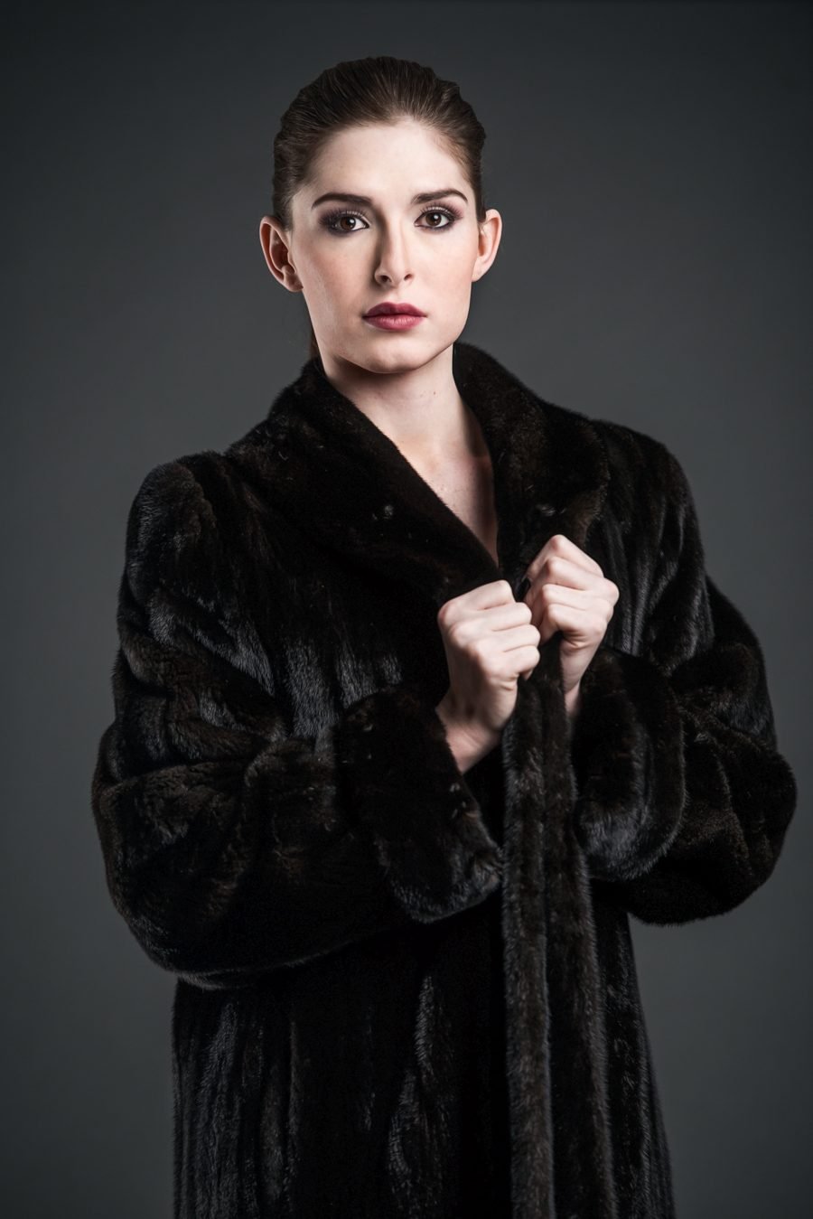 Black and white photo of woman in fur coat in snow