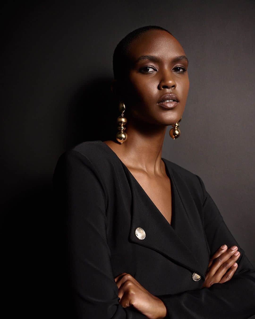 Simple black dress with statement earrings for work