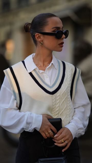 Woman in a sweater vest over a white shirt