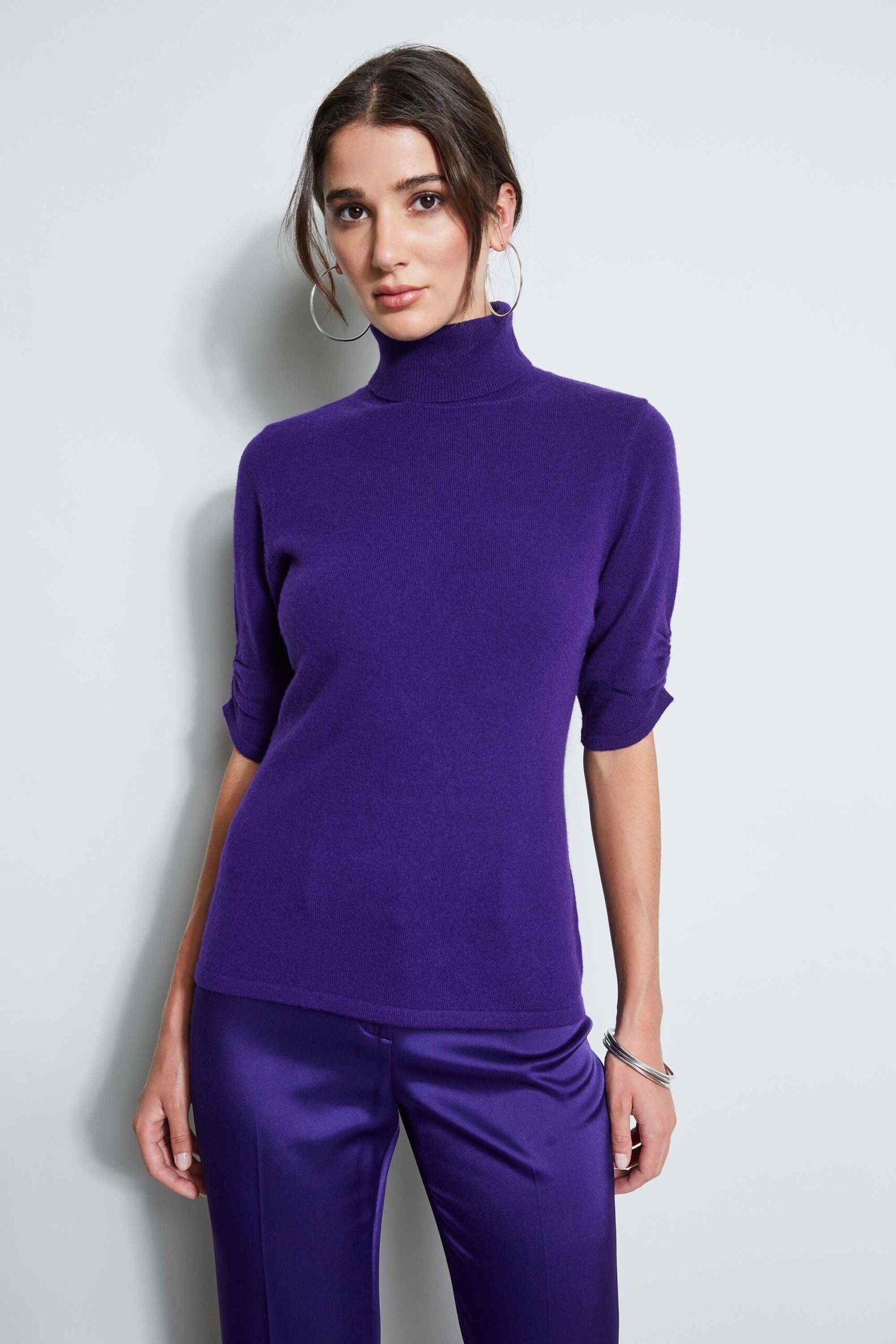 Deep plum turtleneck with silver accessories