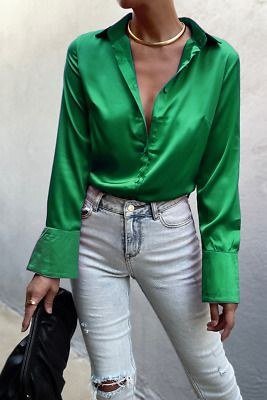 Ripped skinny jeans with an emerald satin blouse