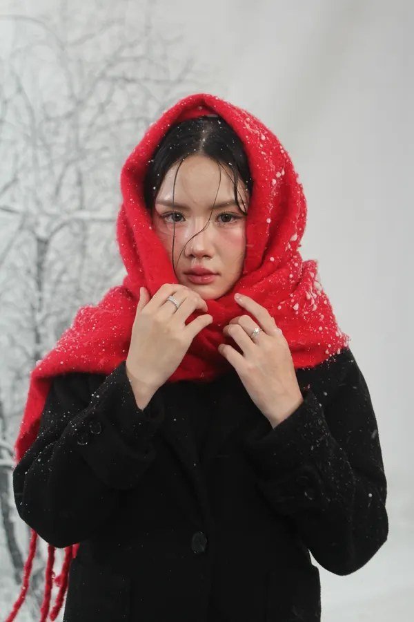Woman in a black dress styled with a red scarf