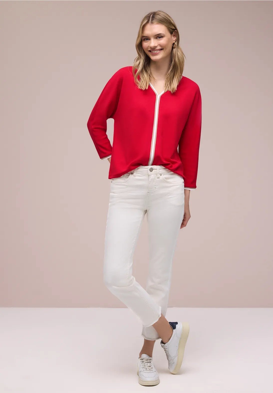 Woman in a red sweater with white jeans, Christmas outfit
