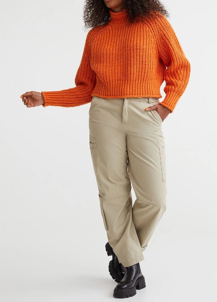 Woman in rust turtleneck sweater with cargo pants