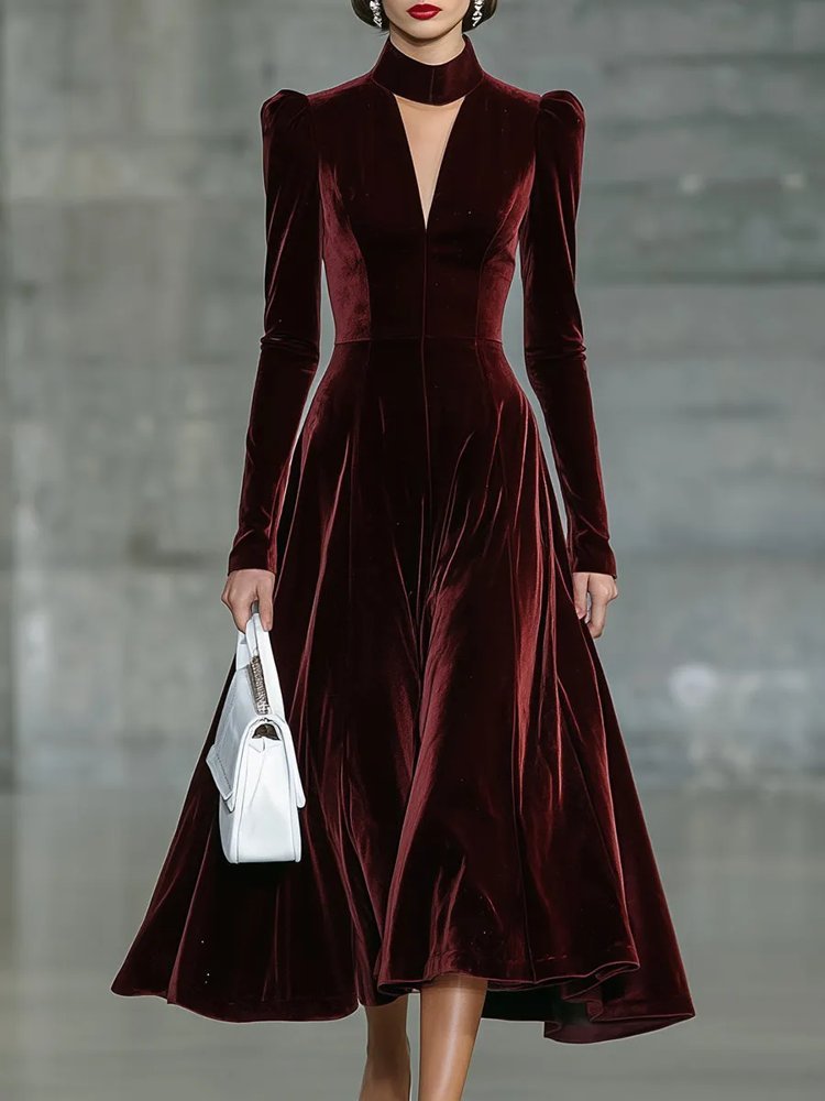 Woman in black trench coat with burgundy velvet dress