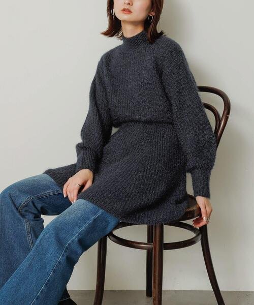 Knit mini skirt over jeans with oversized sweater