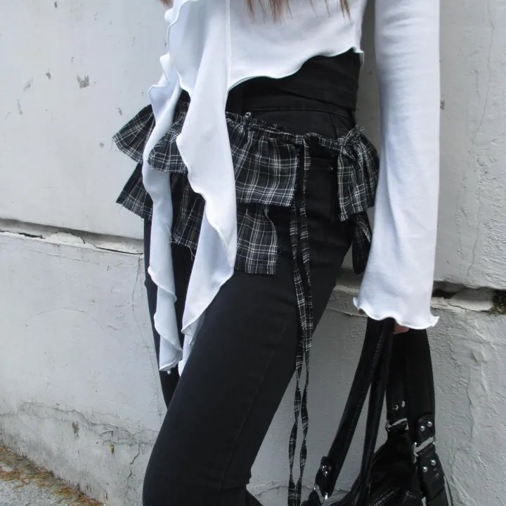 Plaid mini skirt over black skinny jeans