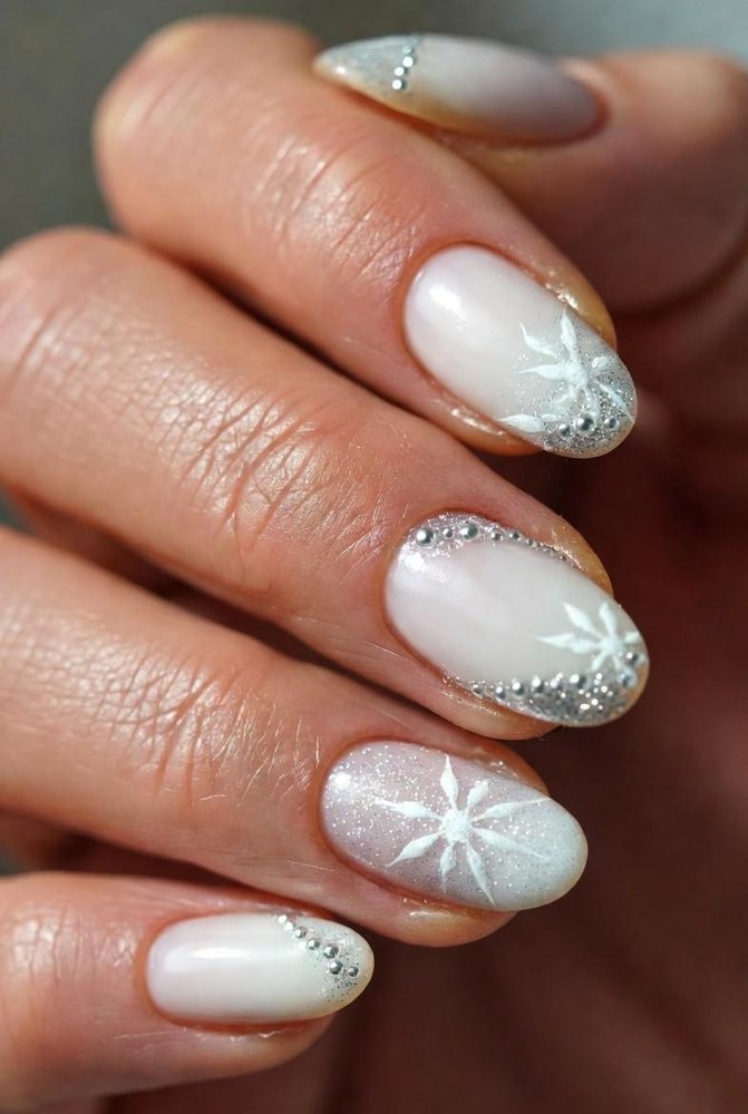 Milky white nails with snowflake nail art