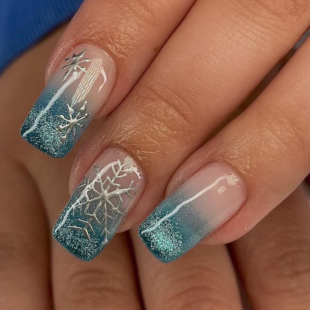 Snowflake art on blue glitter nails