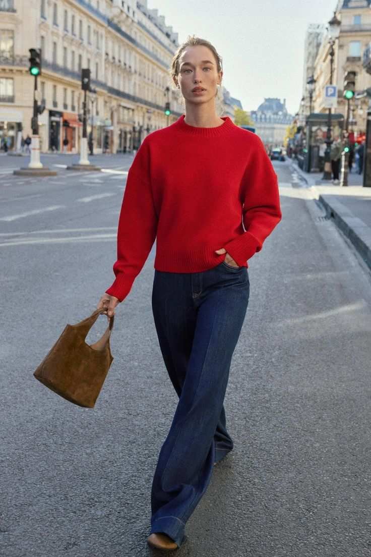 Red sweater with dark jeans Christmas party outfit