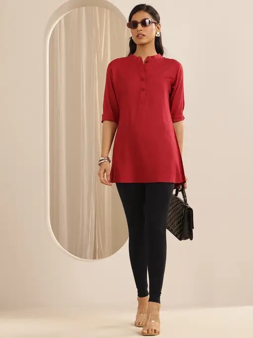 Woman in black leggings with a red tunic, casual outfit