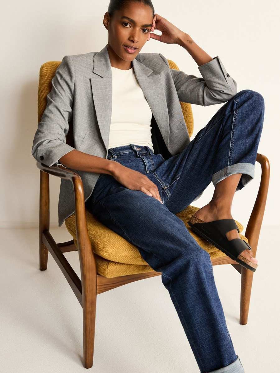Woman wearing boyfriend jeans with a black blazer