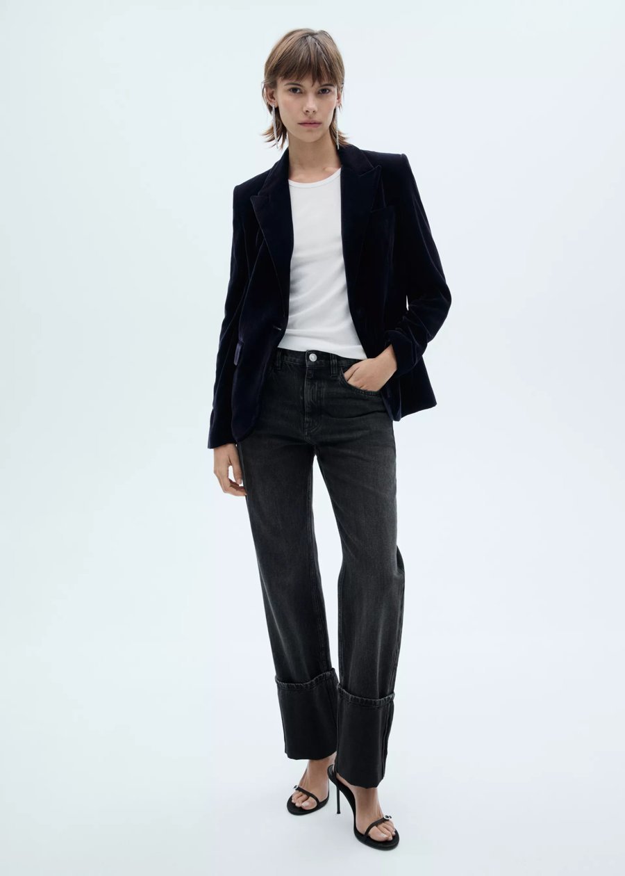 Woman in black jeans with a velvet blazer, evening outfit