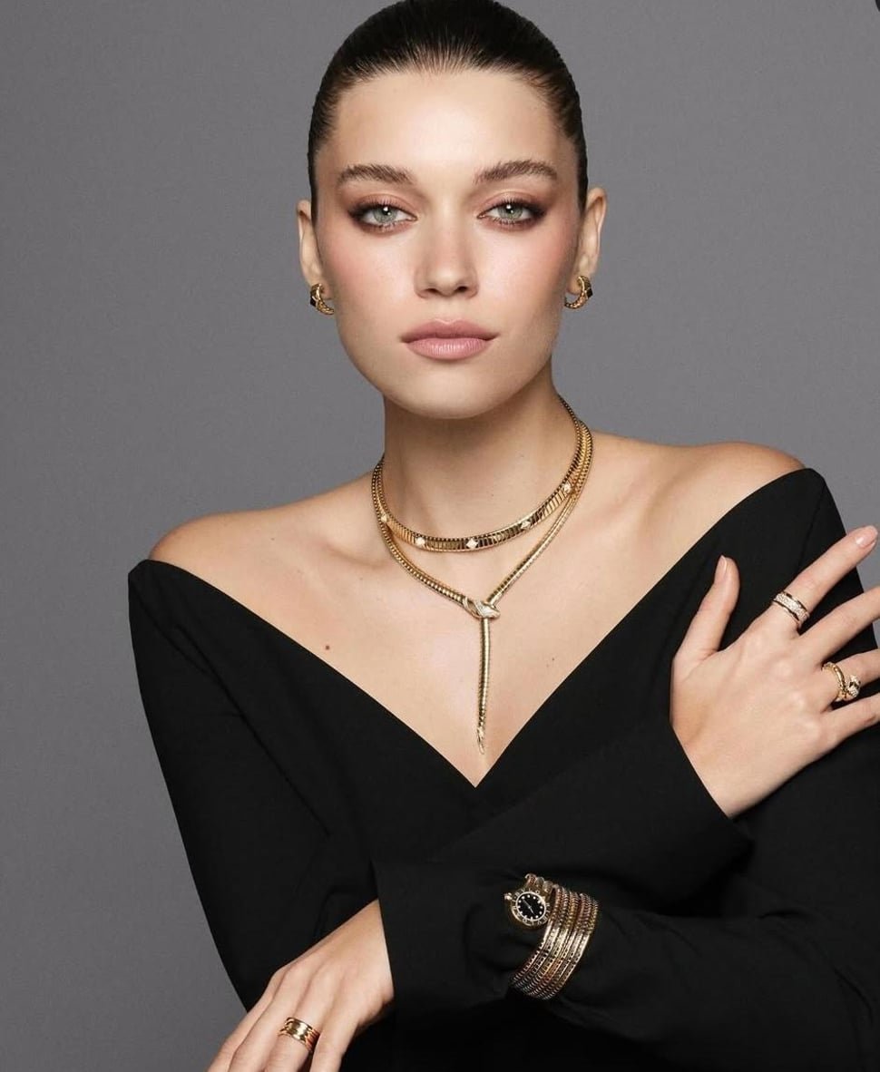 Woman in an off shoulder top with gold jewelry