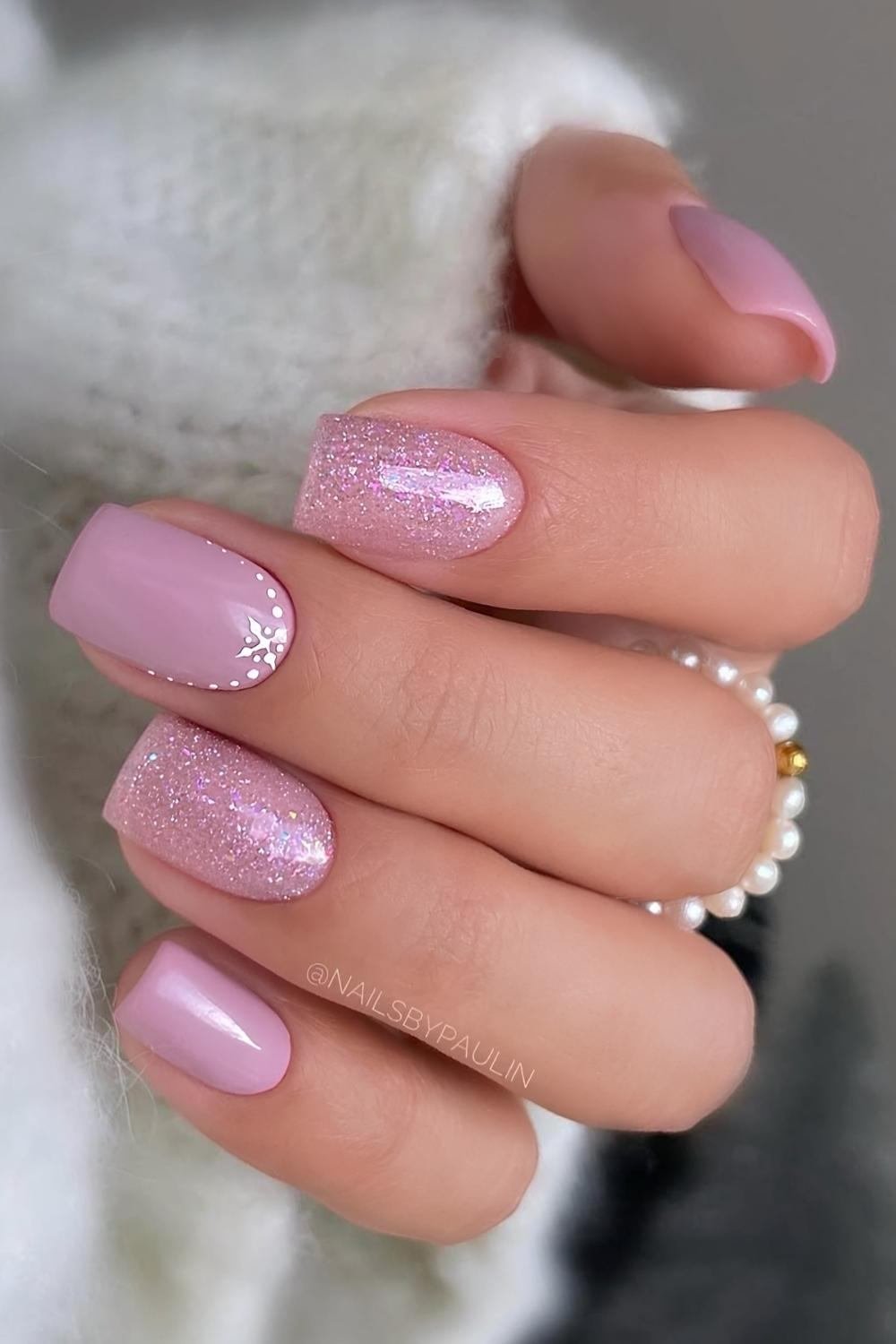 Pink glitter festive winter nails with snowflakes