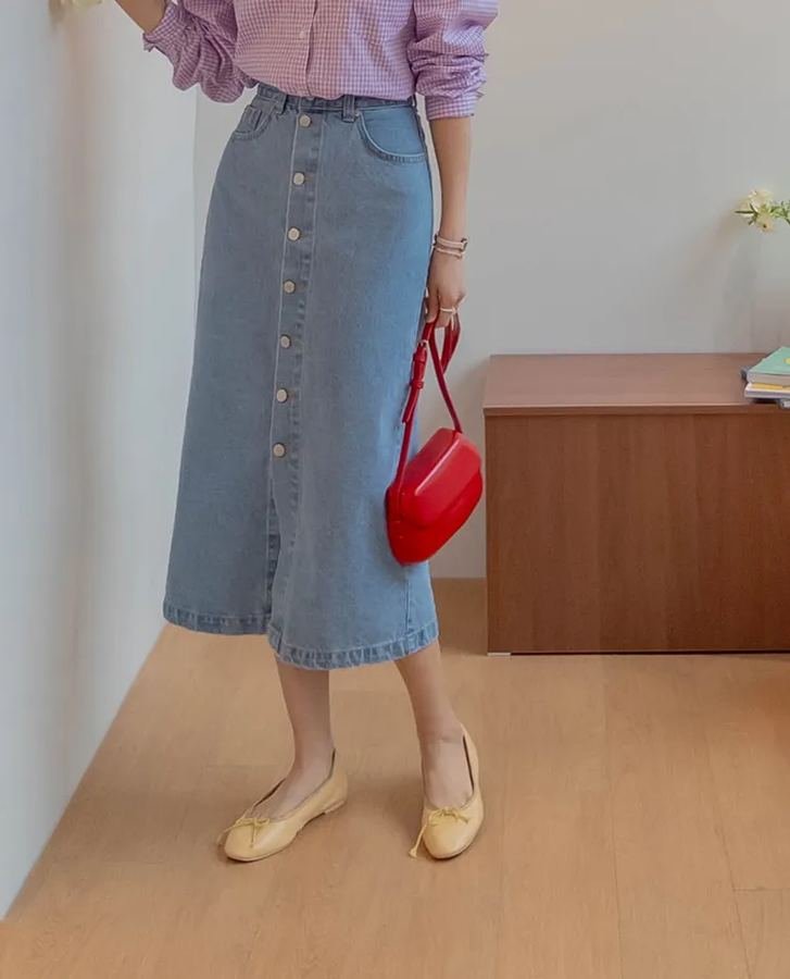 Woman in a classic A-line denim mini skirt with ballet flats