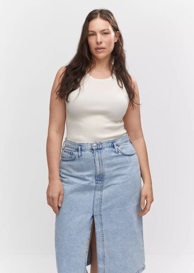 Woman in a ribbed tank top with a denim midi skirt