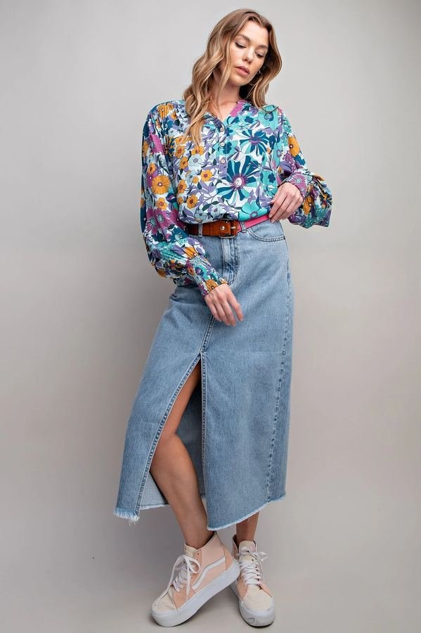 Woman in a pretty blouse with a denim midi skirt at a market