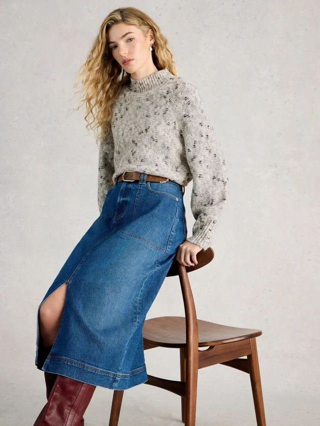 Woman in a soft knit sweater with a relaxed denim midi skirt