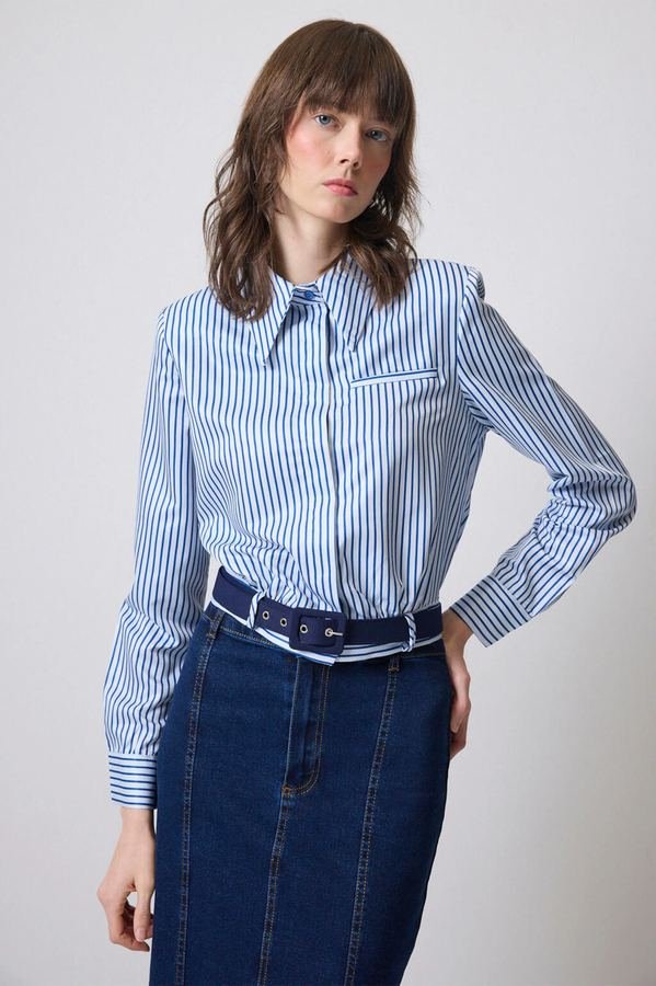 Woman in a striped shirt with a dark denim skirt