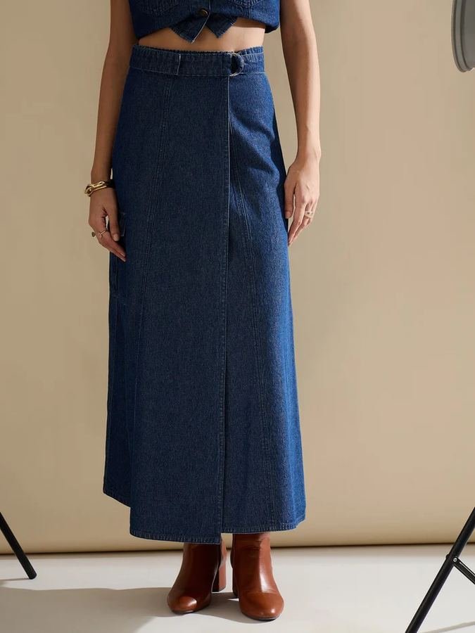 Woman in a wrap top with a high-waist denim midi skirt