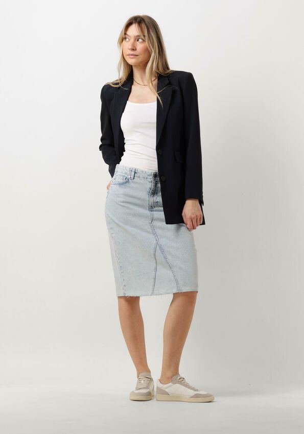 Woman in a raw-hem denim midi skirt styled for the office