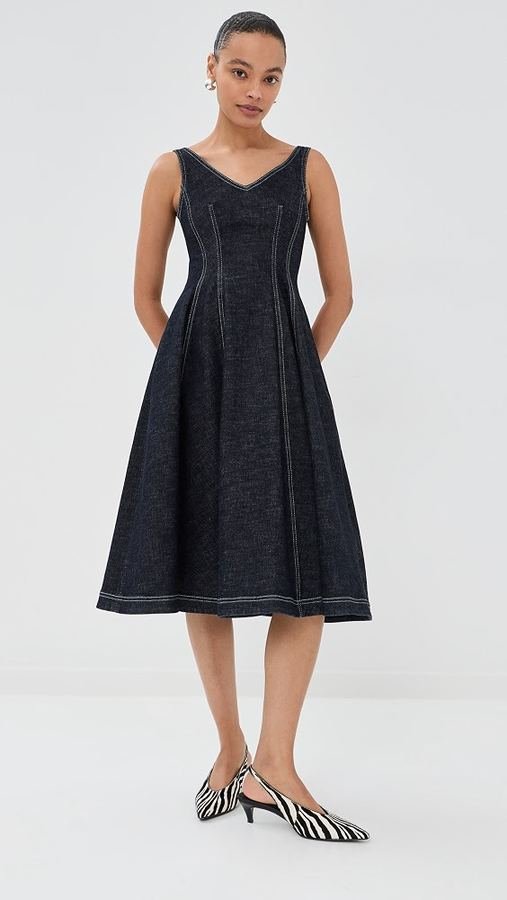 Woman in kitten heels with a dark denim A-line skirt