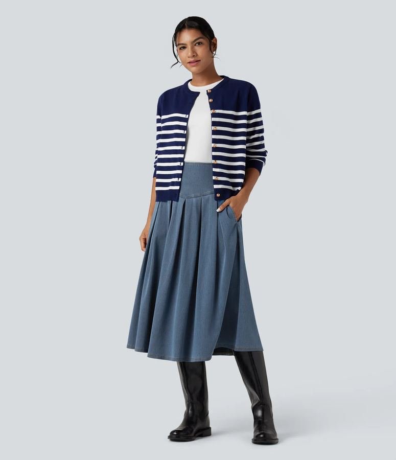 Woman in a fitted cardigan with a pleated denim midi skirt
