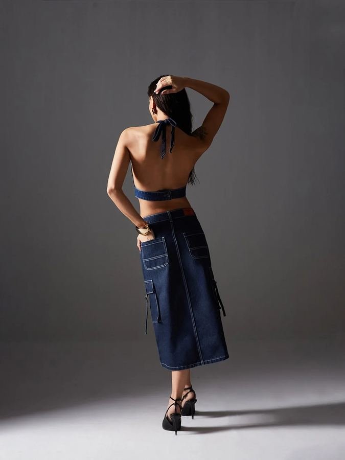 Woman in a backless top with a long denim skirt