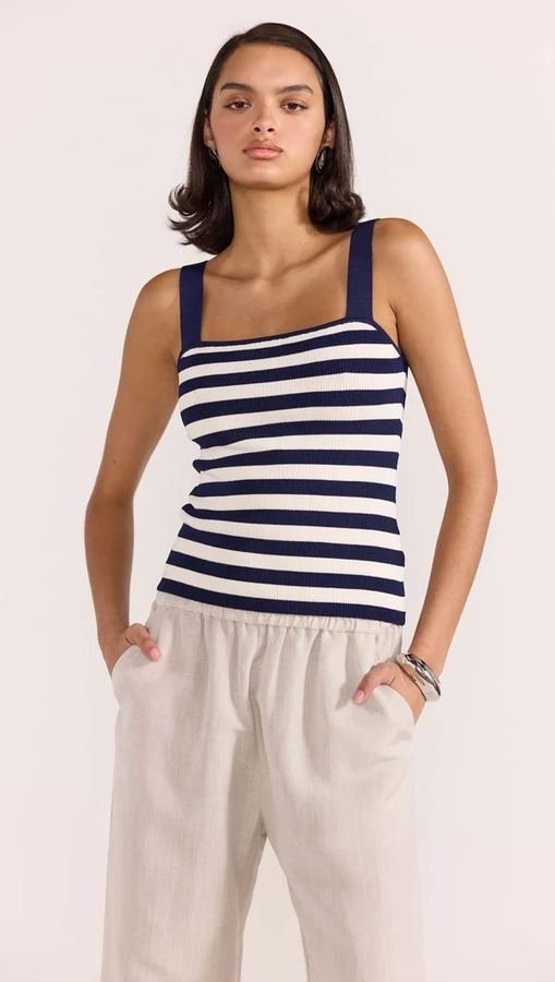 Woman in a Breton stripe top and linen trousers