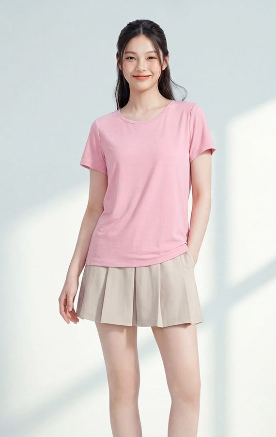 Woman wearing a pleated pastel skirt with a fitted tee