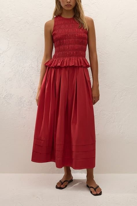 Woman wearing a smocked bodice top with an A-line skirt