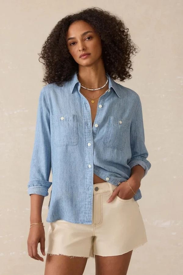 Woman wearing a chambray shirt with cream shorts