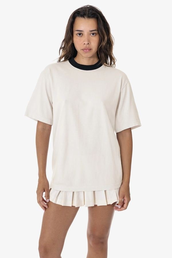 Woman wearing a boxy tee with a pleated tennis skirt