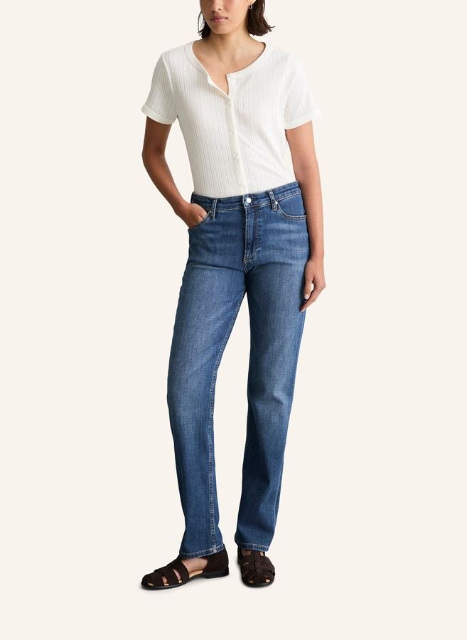 Woman in a henley top and straight-leg jeans