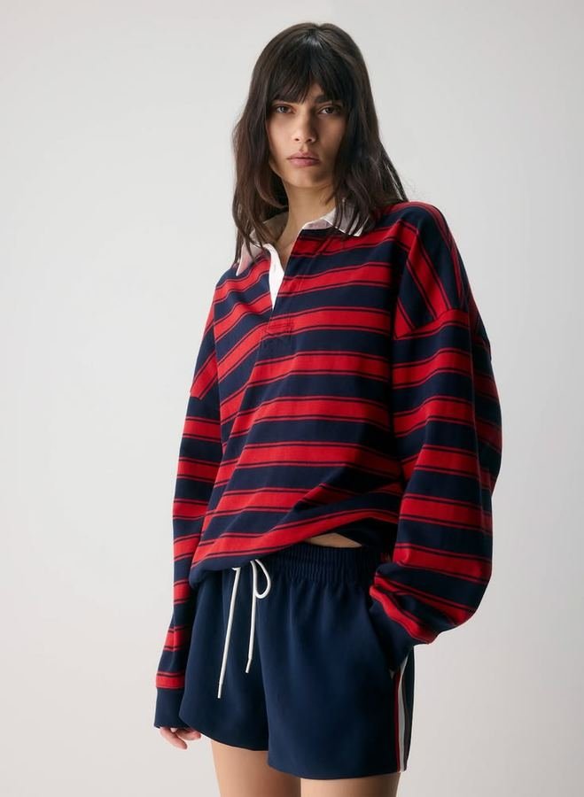 Woman wearing a rugby stripe shirt with chino shorts