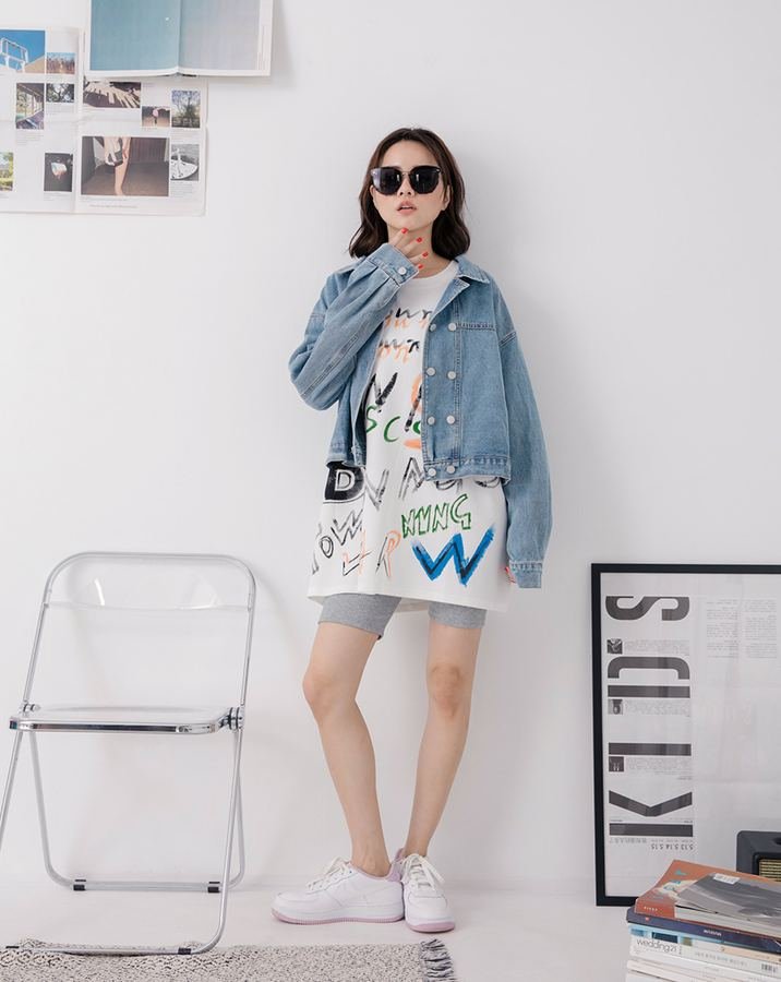 Woman wearing a t-shirt dress with a cropped denim jacket