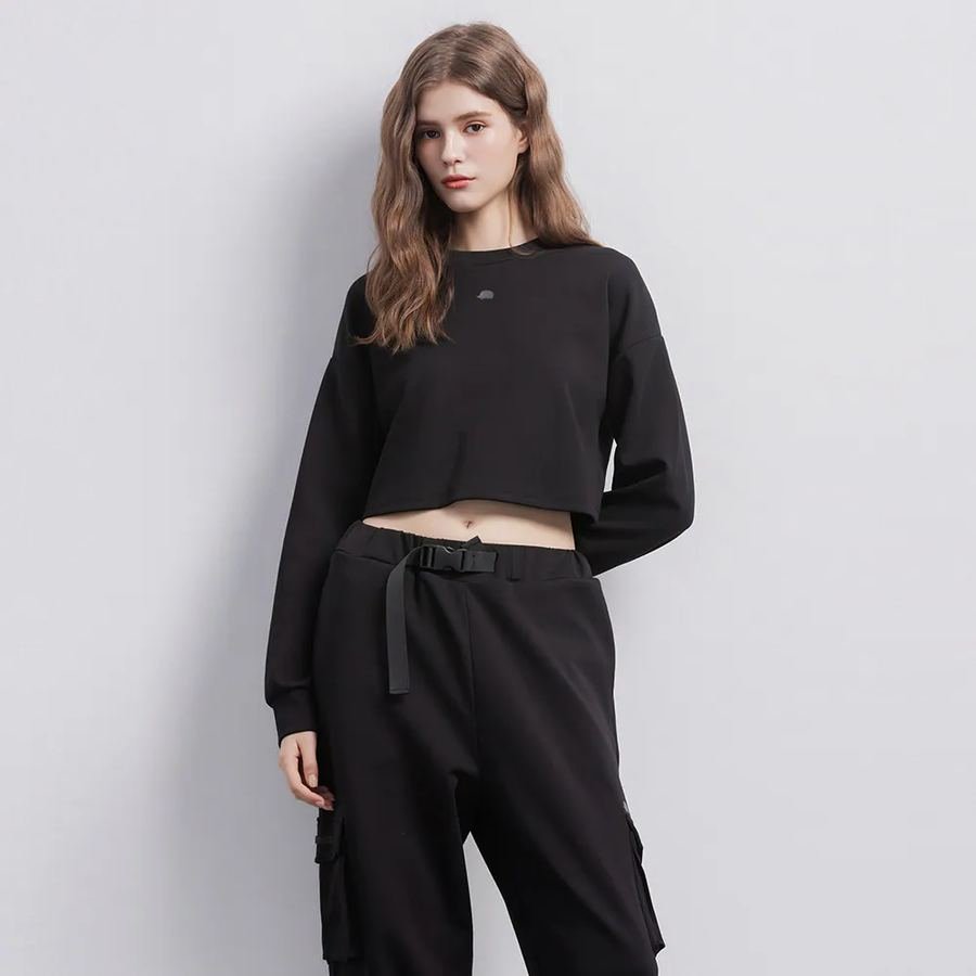 Woman in a cropped sweatshirt and cargo pants